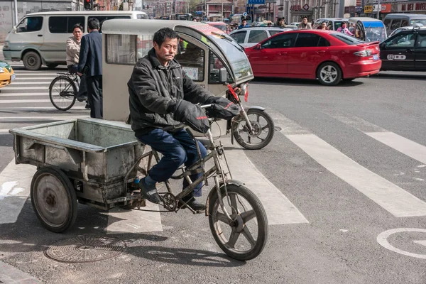 Man rides on freight tricycle in street scene. — Stock Photo, Image