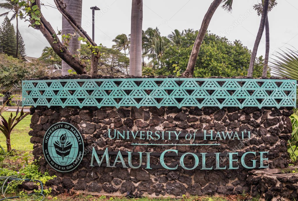 Kahului, Maui,, Hawaii, USA. - January 12, 2020: English language sign for University of Hawaii, Maui college campus, set in green foliage and flower park along W. Kaahumanu Ave. Silver sky.