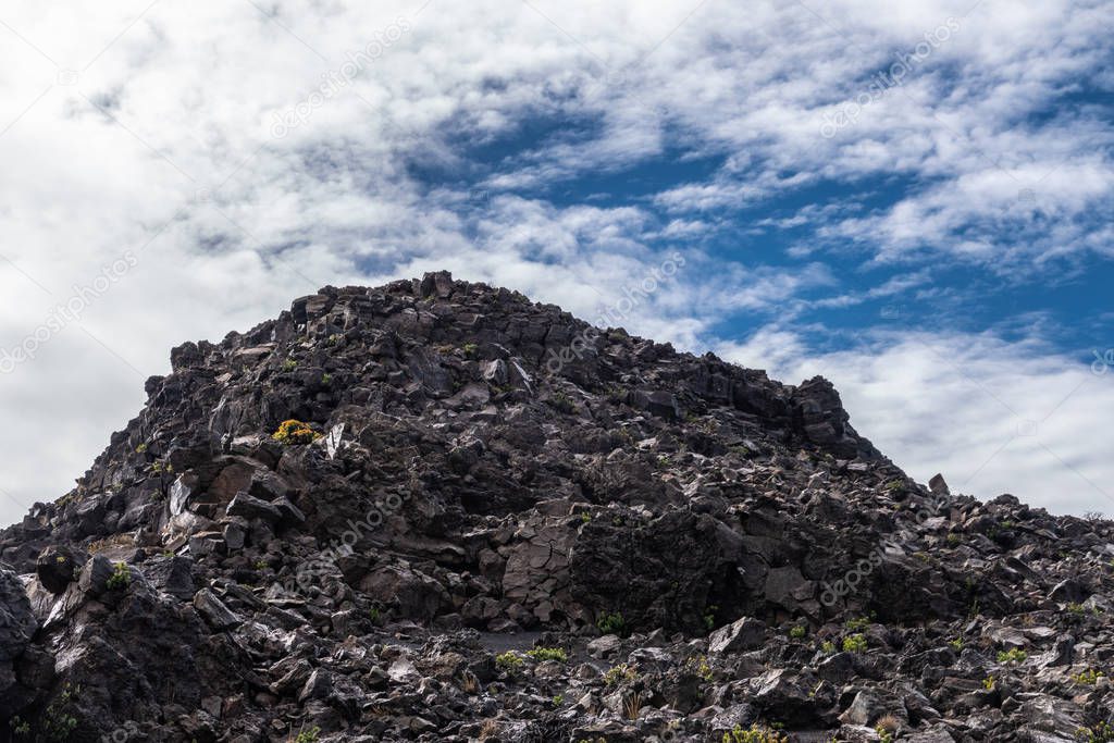 Mountain of lava rocks at edge of crater of Haleakala Volcano, M