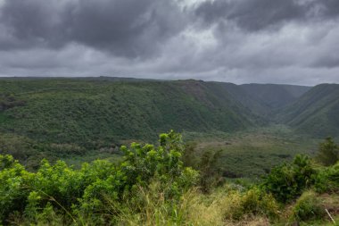 Pololu valley under heavy dark cloudscape, Kohala, Hawaii, USA.