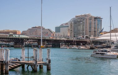 Sydney, Australia - December 11, 2009: Ibis and Mercure hotel buildings on shore of Darling Harbour with small pleasure boats on the water under blue sky.