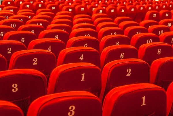 Chongqing, China - May 9, 2010: Downtown. Nothing but numbered red seats inside Great Hall of the People.