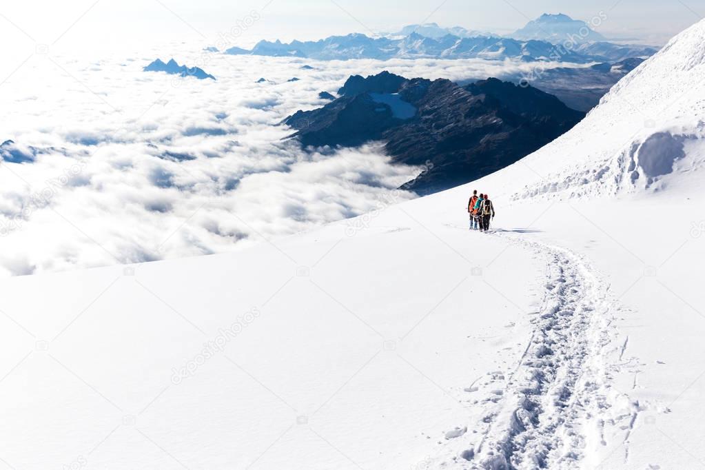 Mountaineers walking climbing snow trail mountains ridge, Bolivia