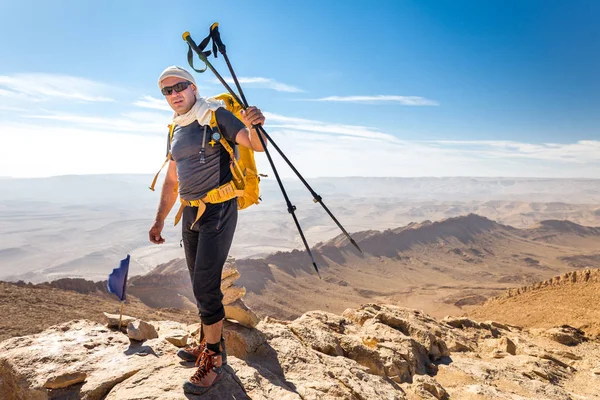 Tourist guide backpacker standing desert mountain summit peak cl