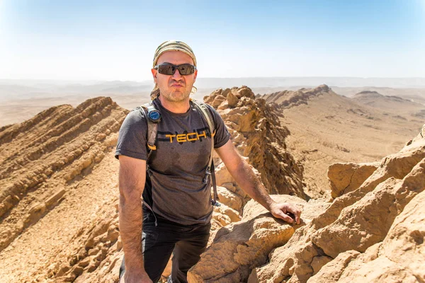 Backpacker tourist standing desert mountain cliff ridge edge lan