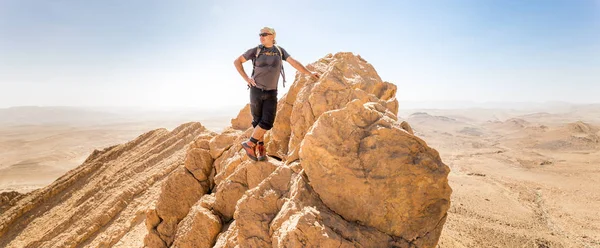 Backpacker tourist standing desert mountain cliff ridge edge lan