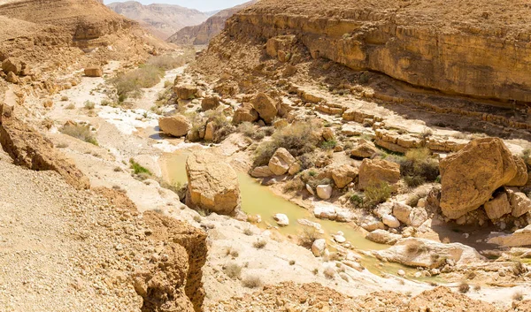 Desert spring lake pit deep canyon cliffs landscape view.