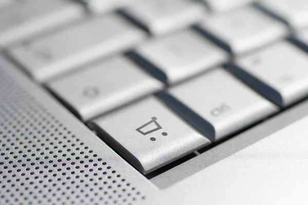 Close up shot of a laptop keyboard with a cart key in focus. — Stock Photo, Image