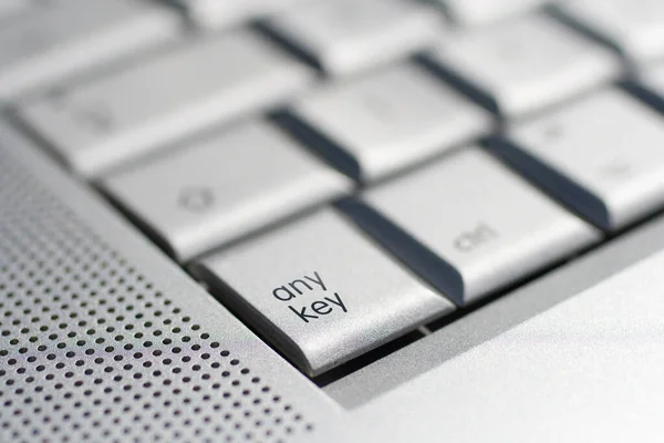 Close up shot of a laptop keyboard with the any key in focus. — Stock Photo, Image