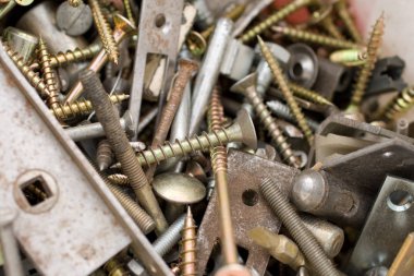 Rusty nails and tapping screws in a bucket