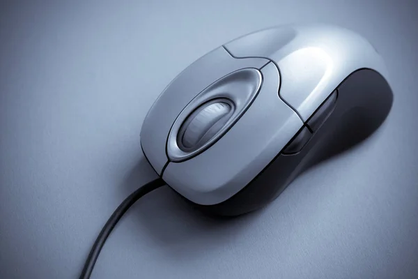 Close up shot of a computer mouse on solid color background — 스톡 사진