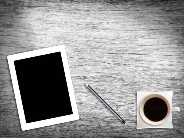 Wooden desk table with tablet pencil and coffee cup ,Top view .