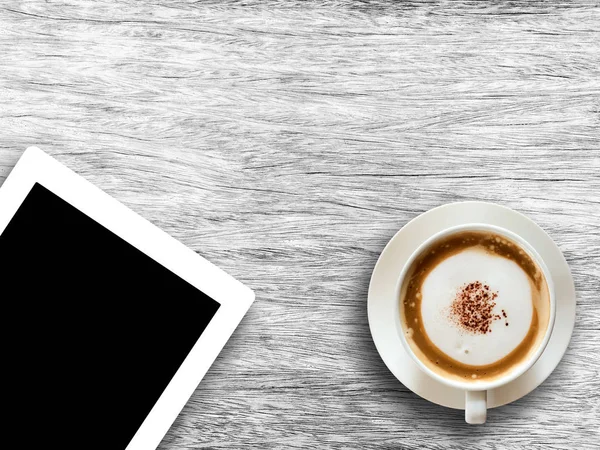 Coffee cup and tablet on wooden table background textured. — Stock Photo, Image