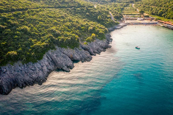 Aerial view of Trsteno beach in Montenegro, near Budva, in a beautiful bay with a rocky shore, blue water — Stock Photo, Image
