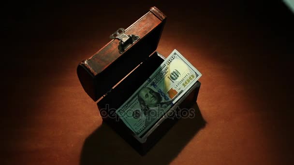 Shadow economy. 100 Dollars. Money falls in the ancient chest. 100 dollars banknotes. Artistic background. — Stock Video