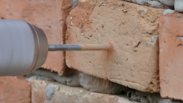 Hole drilling in a brick wall with electric power tool — Stock Video