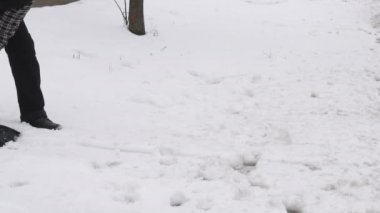 Yetişkin beyaz kürek, kış saati kullanarak kaldırım temizlik kardan adam