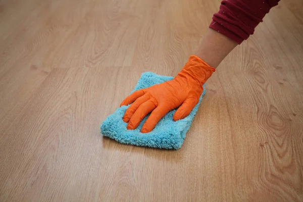 Hand in glove cleaning laminate floor — Stock Photo, Image