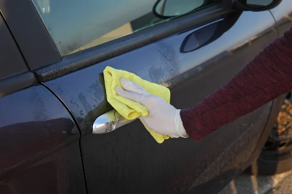 抗菌または洗浄液と布を使用して保護手袋車のドアハンドルの人間の手 — ストック写真