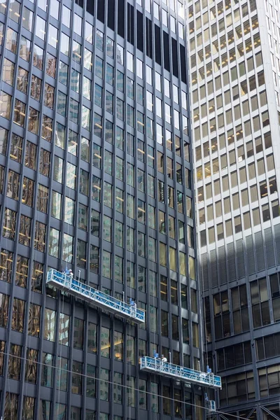 two window cleaning crews working in heights at office tower dow