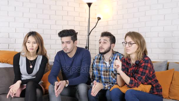Multinational company sit on the couch and watch some video, doing facepalm gesture 50 fps — Stock Video