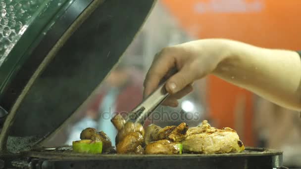 Cook turns the mushrooms on the grill — Stock Video