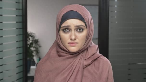 Jeune fille arabe triste en hijab rose pleure, pleure, bouleversé. Concept de deuil Regarde la caméra, portrait. 60 ips — Video