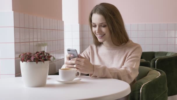 Mulher branca bonita elegante usando smartphone, mensagens de texto, digitação. Sorrindo, rindo 60 fps — Vídeo de Stock