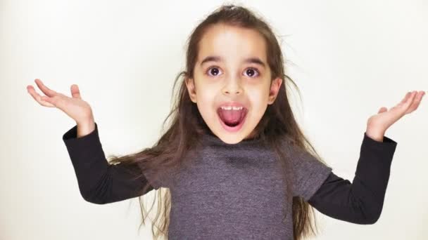 Little cute caucasian girl, smiling, showing an emotion of surprise, wide-open mouth, portrait white background 50 fps — Stock Video