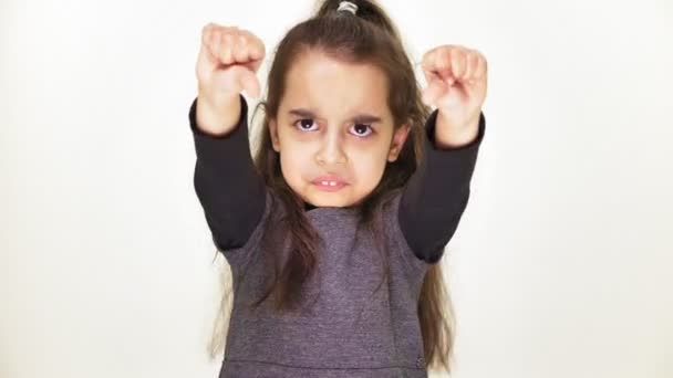 Little sad little girl showing dislike sign, portrait, white background 50 fps — Stock Video