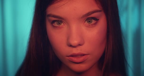 Ögon kaukasiska flicka porträtt ung färg neon lila blå bakgrund — Stockvideo