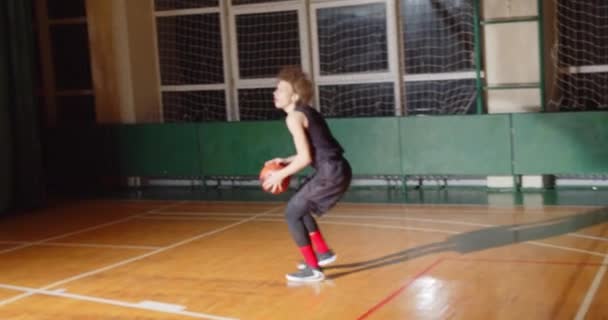 Młody kręcone profesjonalny koszykarz gra rzucając piłkę w koszu noc sylwetka ciemność miss — Wideo stockowe