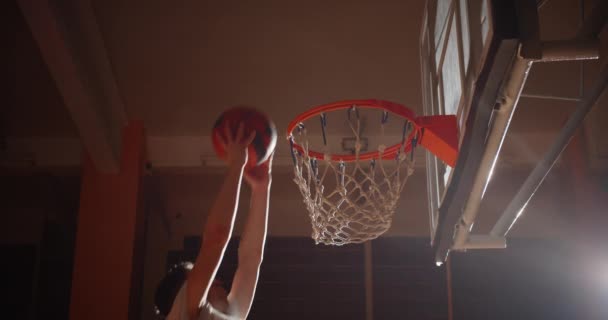 Primer plano canasta baloncesto bola Slam Dunk caucásico jugador saltar rayo de luz — Vídeo de stock