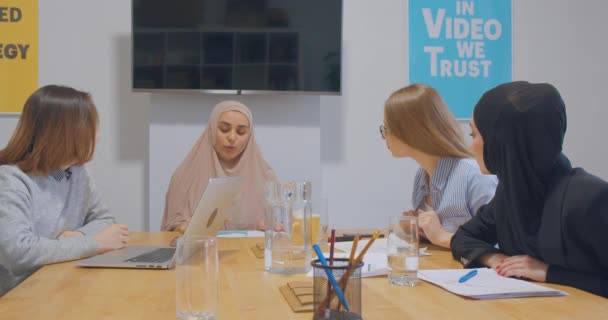 Diverse female colleagues at office talks discussing hijab Asian business plan — Stock Video