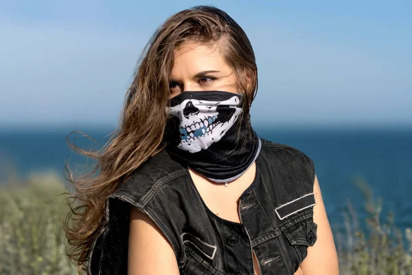 woman in mask with stern look. Hot biker girl. beautiful women