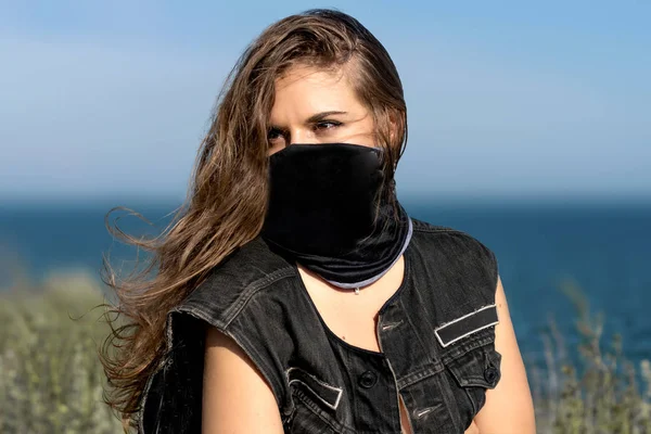 woman in mask with stern look. Hot biker girl. beautiful women