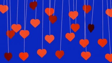 Animated red hearts shapes hanging from threads on dark blue background