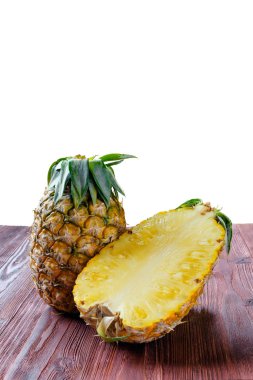 Ananas ile bir buçuk bir dilim üzerinde ahşap masa.