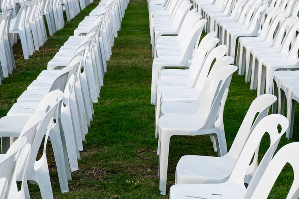 White Plastic Chairs Pattern Row.