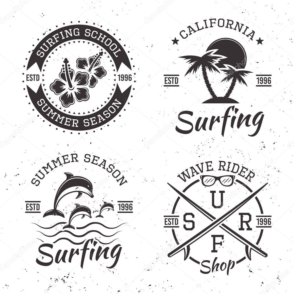 Surfing set of four black vector vintage emblems