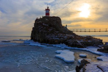 Lighthouse at Cape Basargin, Golden Horn Bay, Vladivostok symbol. Russky island. Landscape panorama. Sea of Japan. clipart