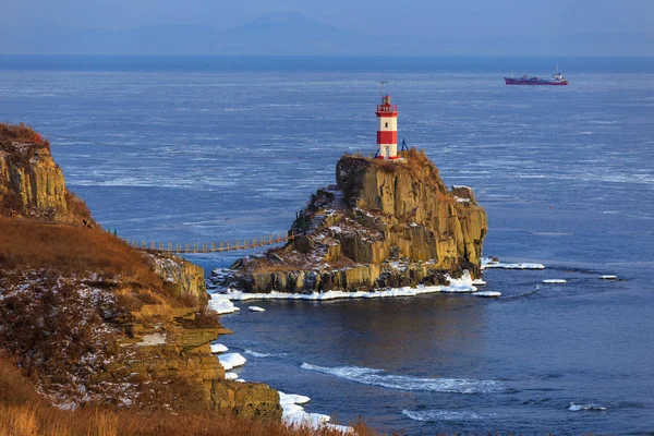 Lighthouse at Cape Basargin, Golden Horn Bay, Vladivostok symbol. Russky island. Landscape panorama. Sea of Japan.