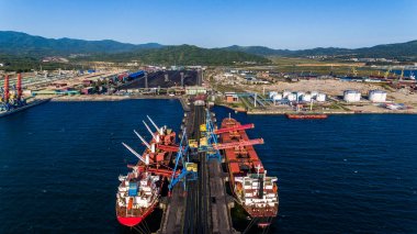 NAKHODKA, RUSSIA - CIRCA AUGUST, 2017: Coal terminals in the port of Nakhodka. It is the largest port in Russia, the main export goods in the port of Nakhodka are coal, oil, wood and metals clipart