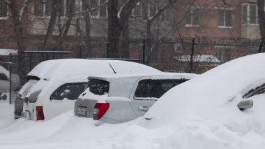 Arabalar bir kar yağışı sırasında git karla kaplı şehir, şehir Vladivostok, ağır çekim çekim