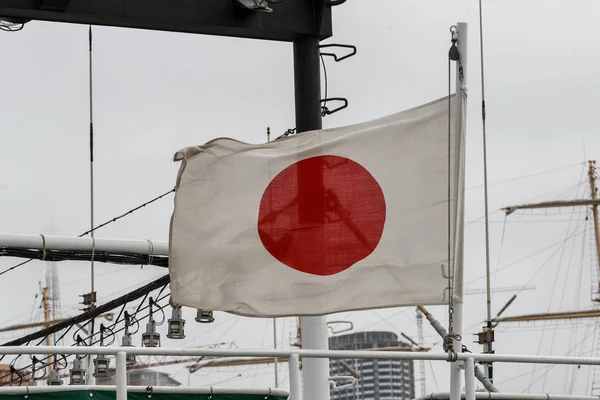Close-up. The Japanese flag is developing on a sea ship.