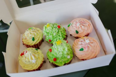 Yeni yıl hediyeleri. Çok renkli kekler beyaz bir kutuda yatıyor..