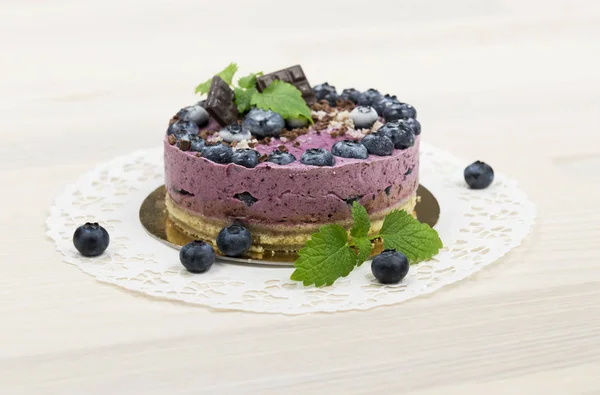 Raw vegan blueberry cake on the light wooden surface Stock Photo