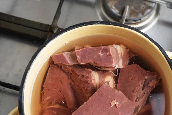 Beef heart in a pot of water on a gas stove — Stock Image Beef heart in a pot of water on a gas stove Royalty Free Stock Photos