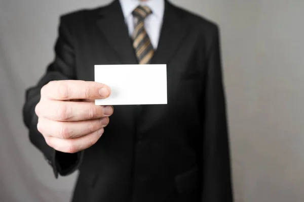 Businessman holding a business card. Mock up. Copy space. — Stock Photo, Image