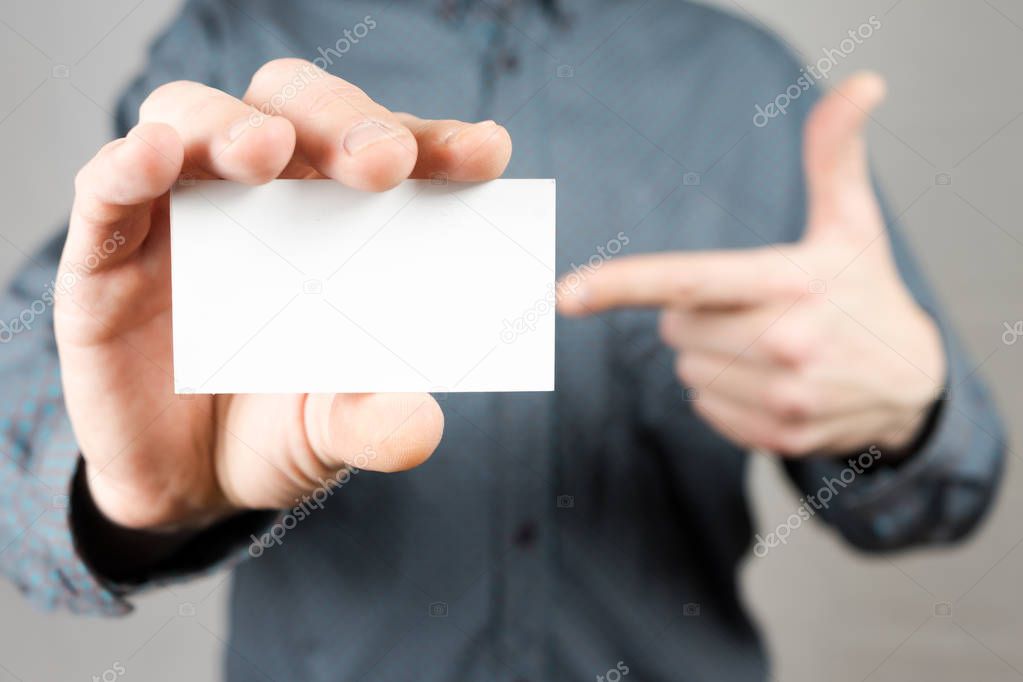 Businessman holding a business card. Mock up. Copy space.